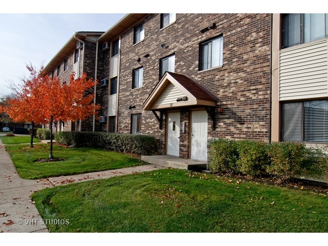 a front view of a house with a yard and pathway