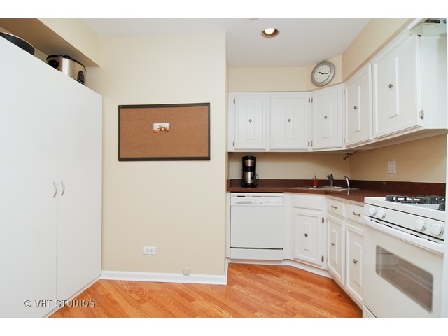 12 Parkside Court, Unit 4 Vernon Hills, IL 60061 - Photo 4 of 16 a view of cabinets with stainless steel appliances granite countertop cabinets and sink