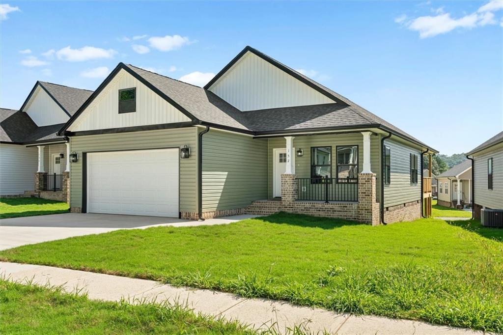 a view of a house with a yard and pathway
