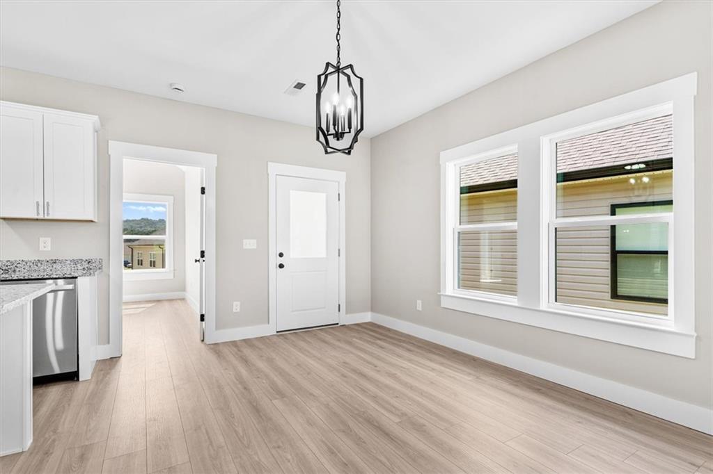 152 Washington Street Dalton, GA 30721 - Photo 11 of 40 a view of an empty room with a window and wooden floor