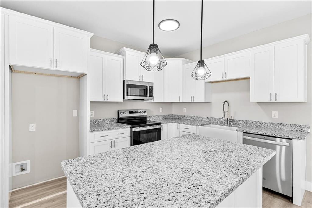 152 Washington Street Dalton, GA 30721 - Photo 14 of 40 a kitchen with stainless steel appliances granite countertop a sink stove and refrigerator