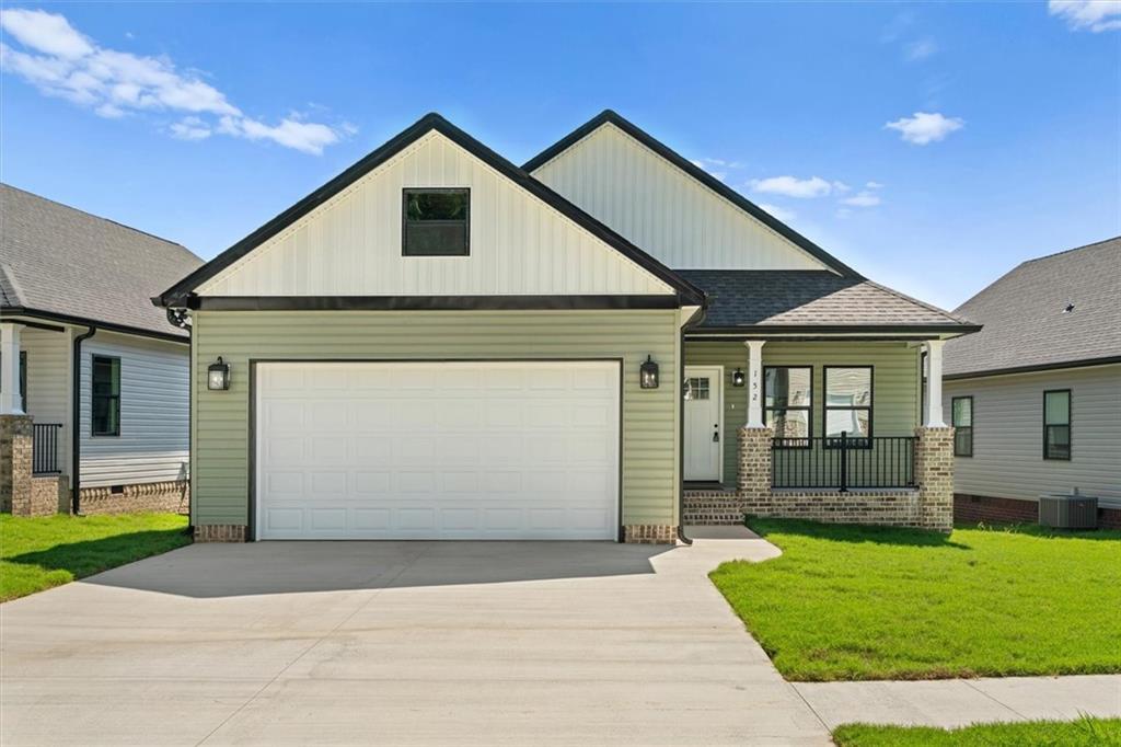 152 Washington Street Dalton, GA 30721 - Photo 2 of 40 a front view of a house with a yard and garage