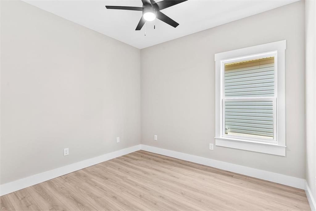 152 Washington Street Dalton, GA 30721 - Photo 27 of 40 an empty room with a window and a ceiling fan