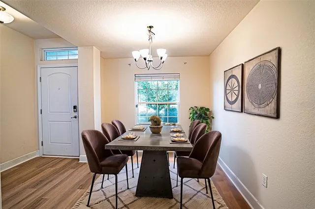 a view of a dining room with furniture window and wooden floor