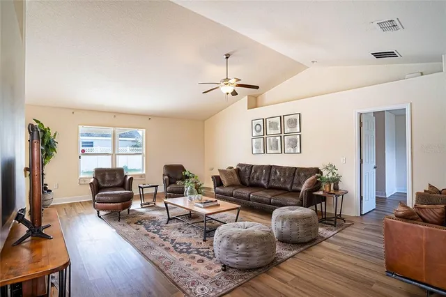a living room with furniture window and wooden floor
