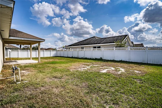 a view of a house with a backyard