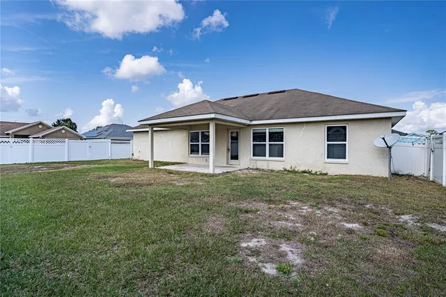 a view of a house with a backyard