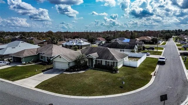 an aerial view of a house with outdoor space