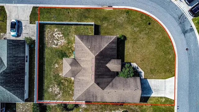 an aerial view of a house with a yard