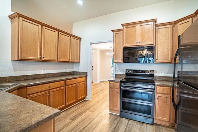 a kitchen with stainless steel appliances granite countertop a stove a sink and a microwave