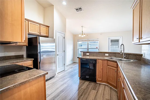 a kitchen with a sink stove and refrigerator