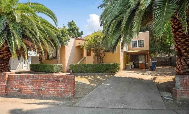 a front view of a house with a yard