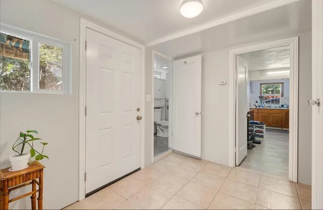 a view of a hallway to rooms and a dining room