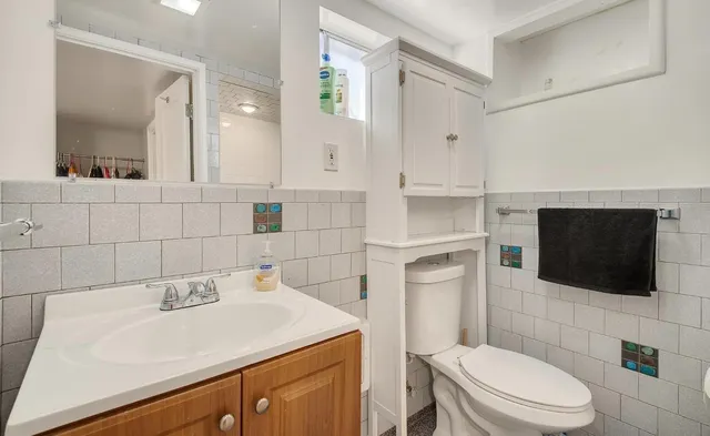 a bathroom with a sink a toilet and mirror