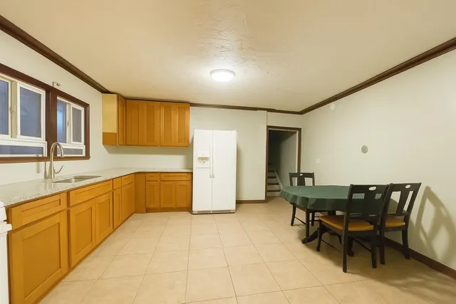 a large kitchen with a table and chairs
