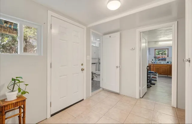 a view of a hallway to rooms and a dining room