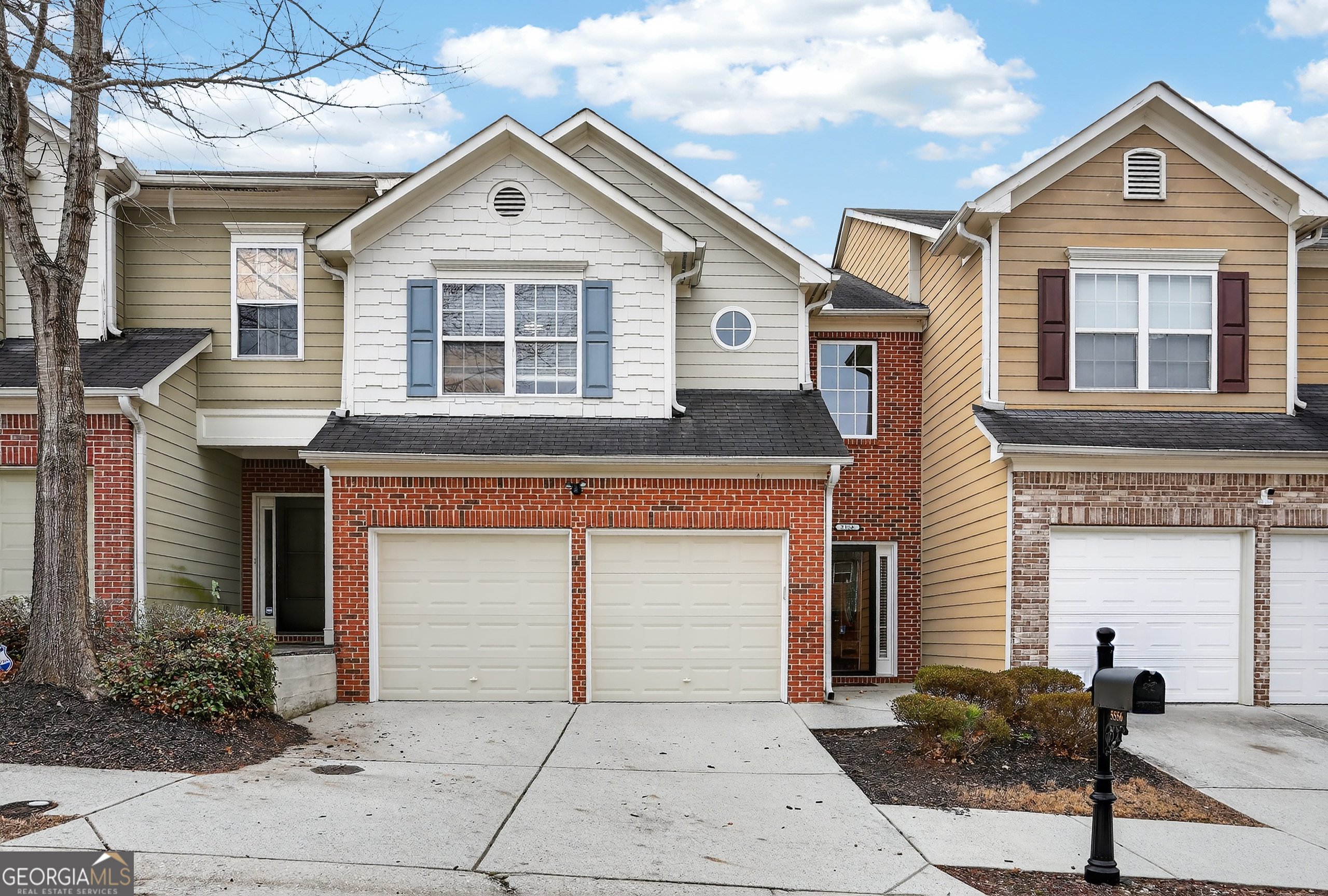 a view of a brick house with large windows