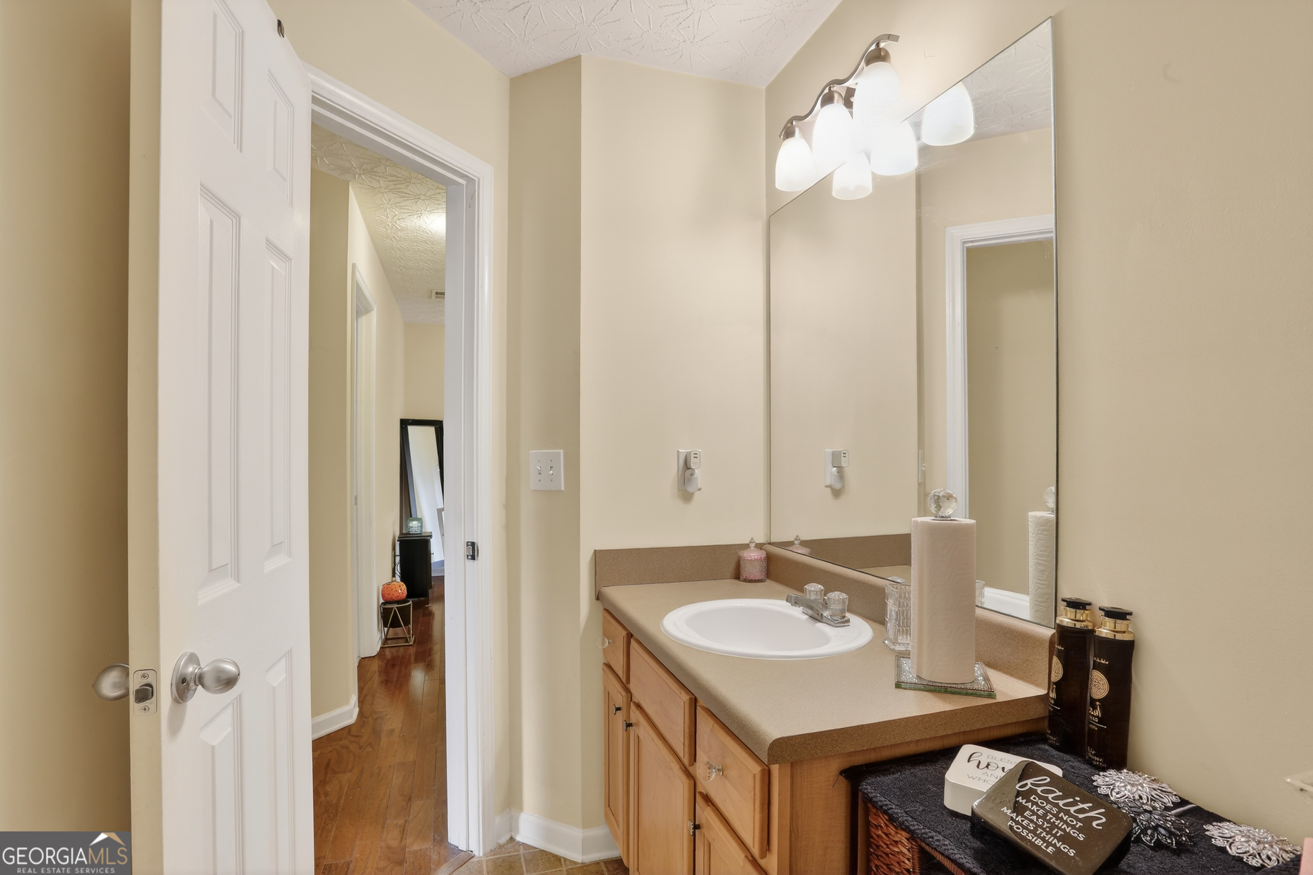 5556 Cascade Run South Fulton, GA 30336 - Photo 15 of 35 a bathroom with a granite countertop sink and a mirror