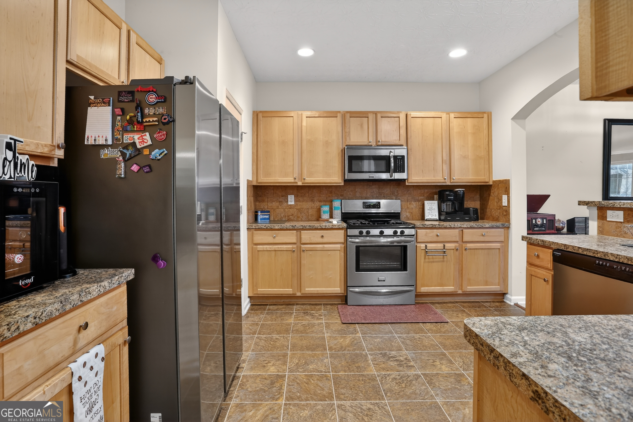 5556 Cascade Run South Fulton, GA 30336 - Photo 19 of 35 a kitchen with stainless steel appliances granite countertop a refrigerator sink and stove