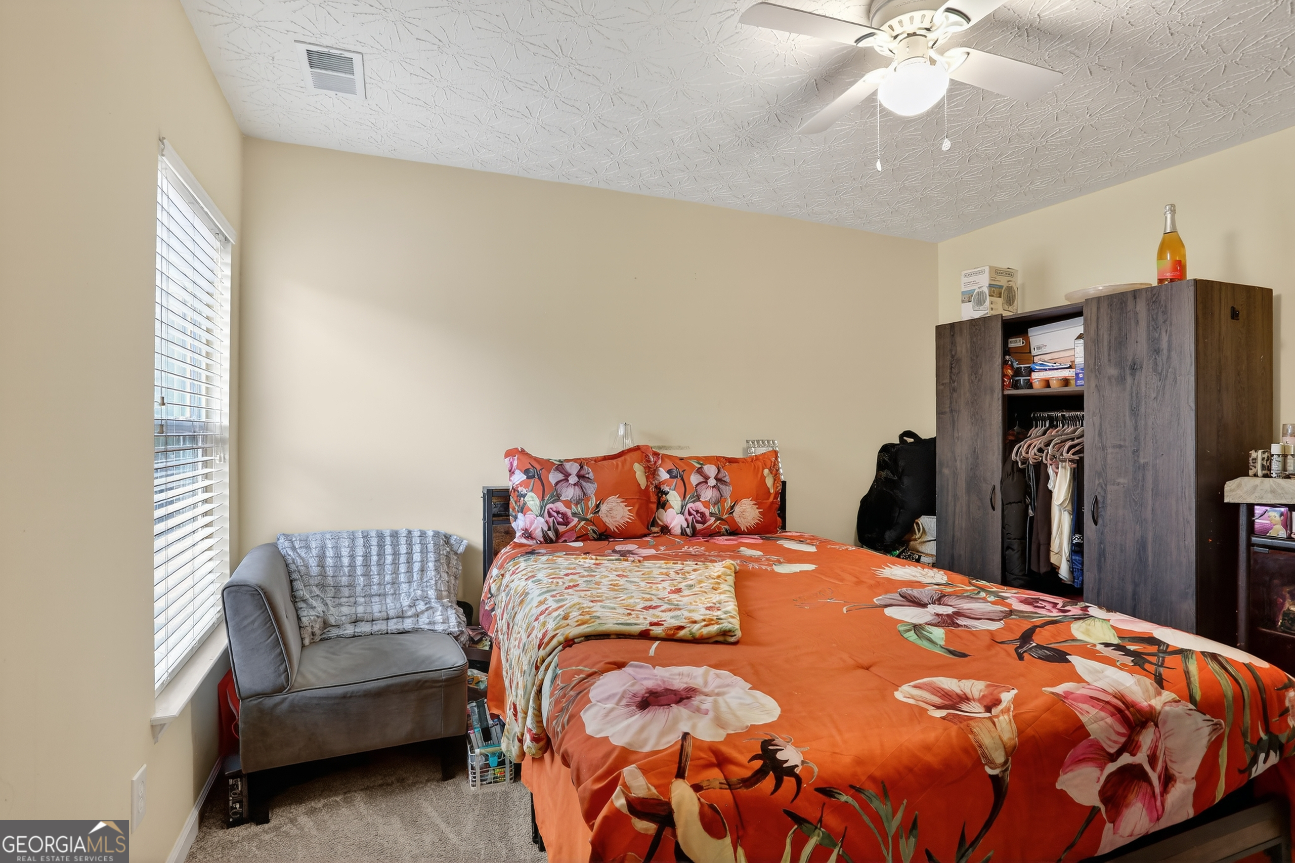 5556 Cascade Run South Fulton, GA 30336 - Photo 22 of 35 a bedroom with a bed and a chandelier