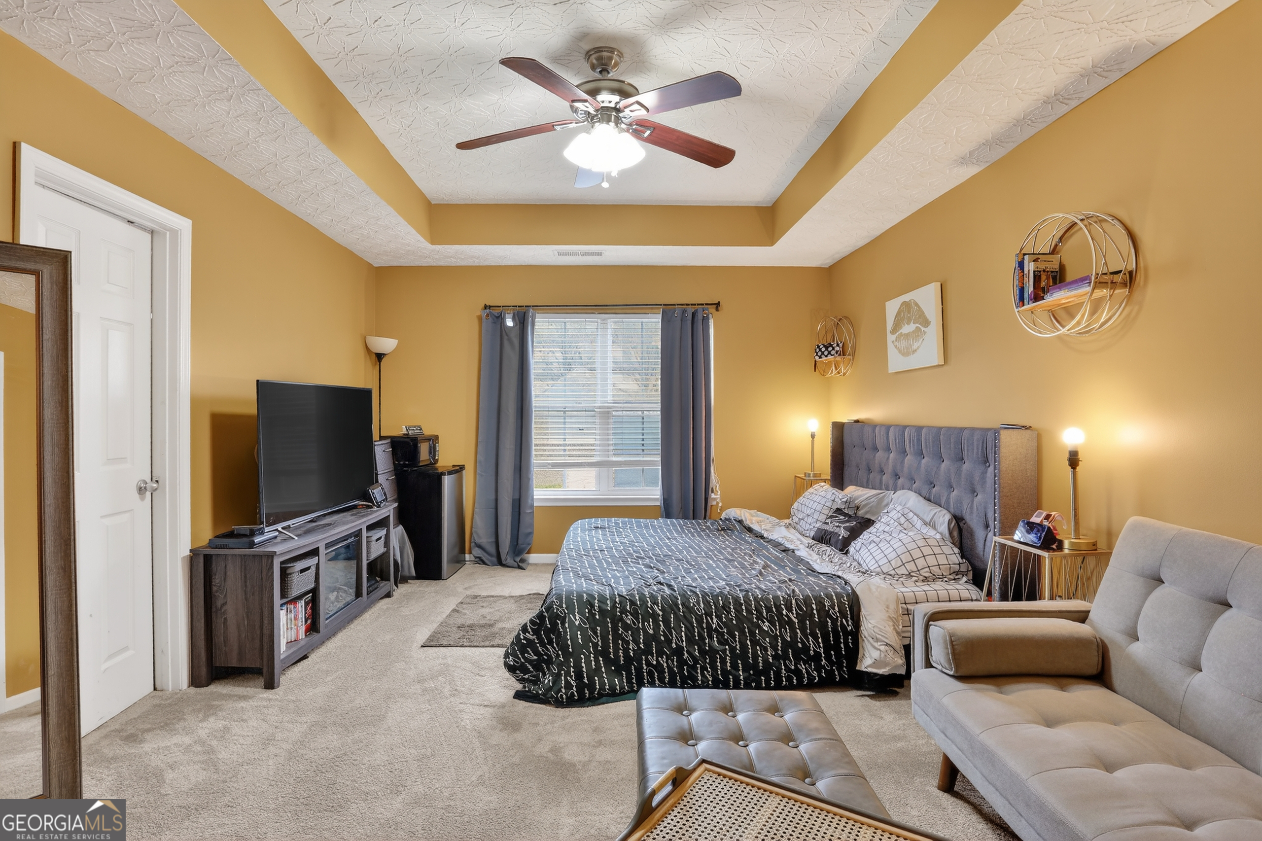 5556 Cascade Run South Fulton, GA 30336 - Photo 25 of 35 a spacious bedroom with a bed and a flat screen tv