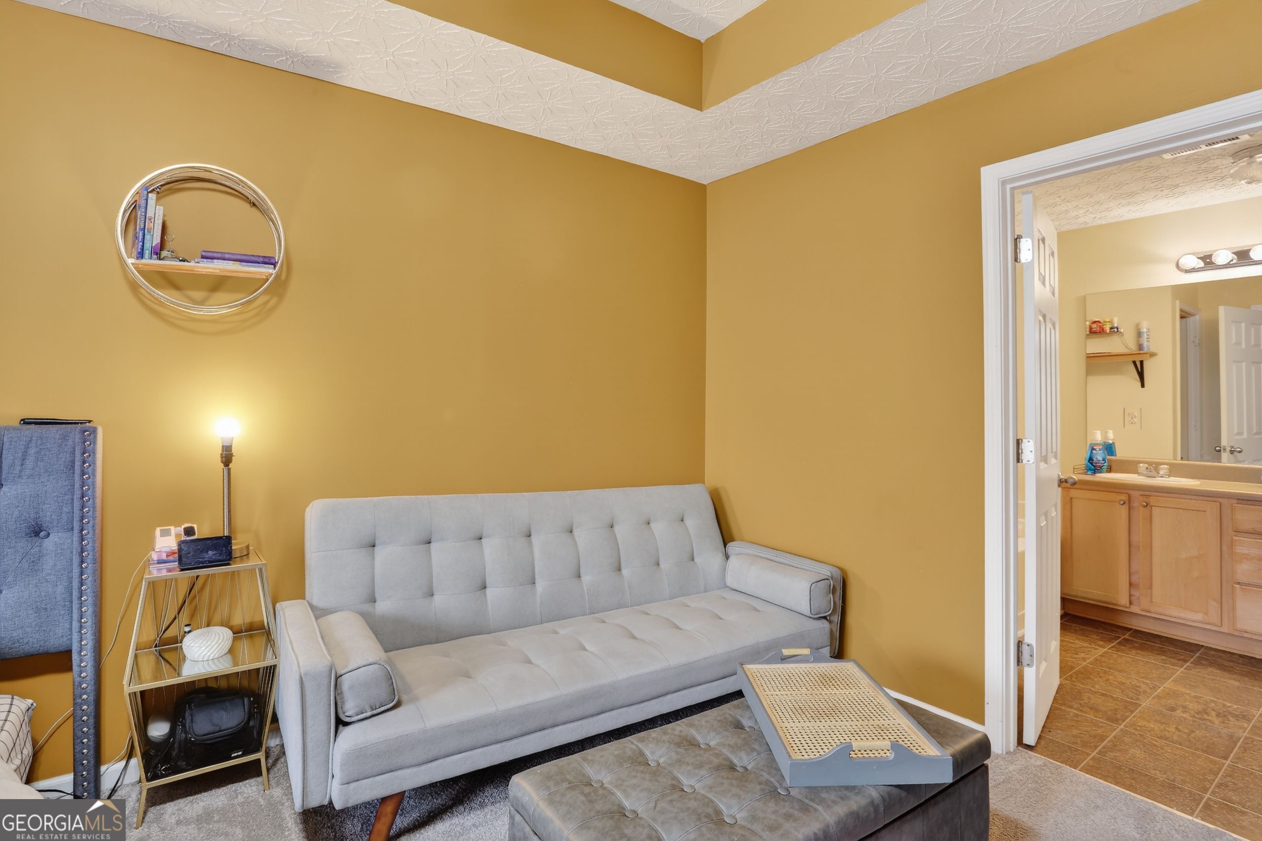 5556 Cascade Run South Fulton, GA 30336 - Photo 26 of 35 a living room with a couch and a view of en suite bathroom