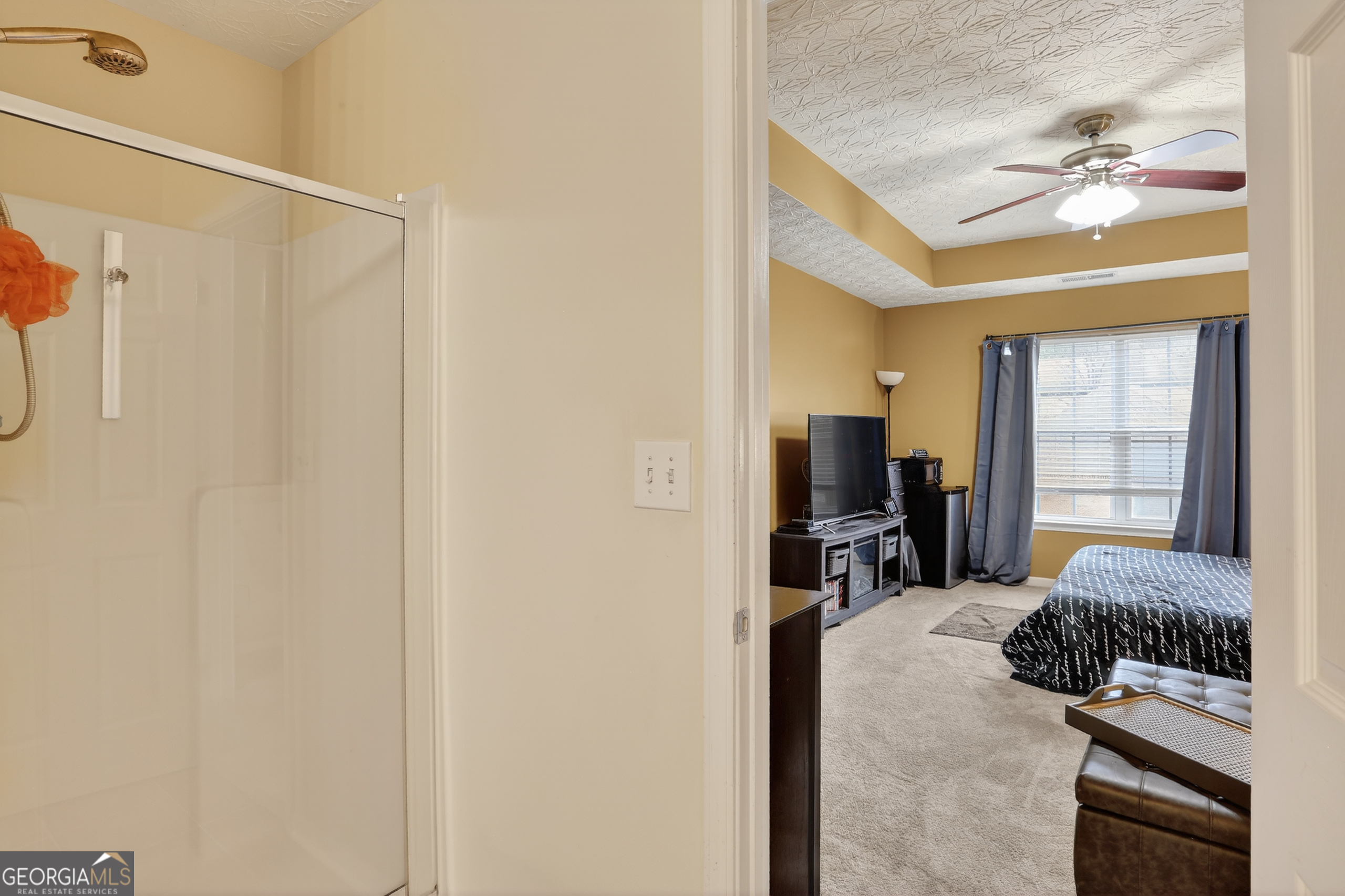 5556 Cascade Run South Fulton, GA 30336 - Photo 29 of 35 a bedroom with a bed and a chandelier