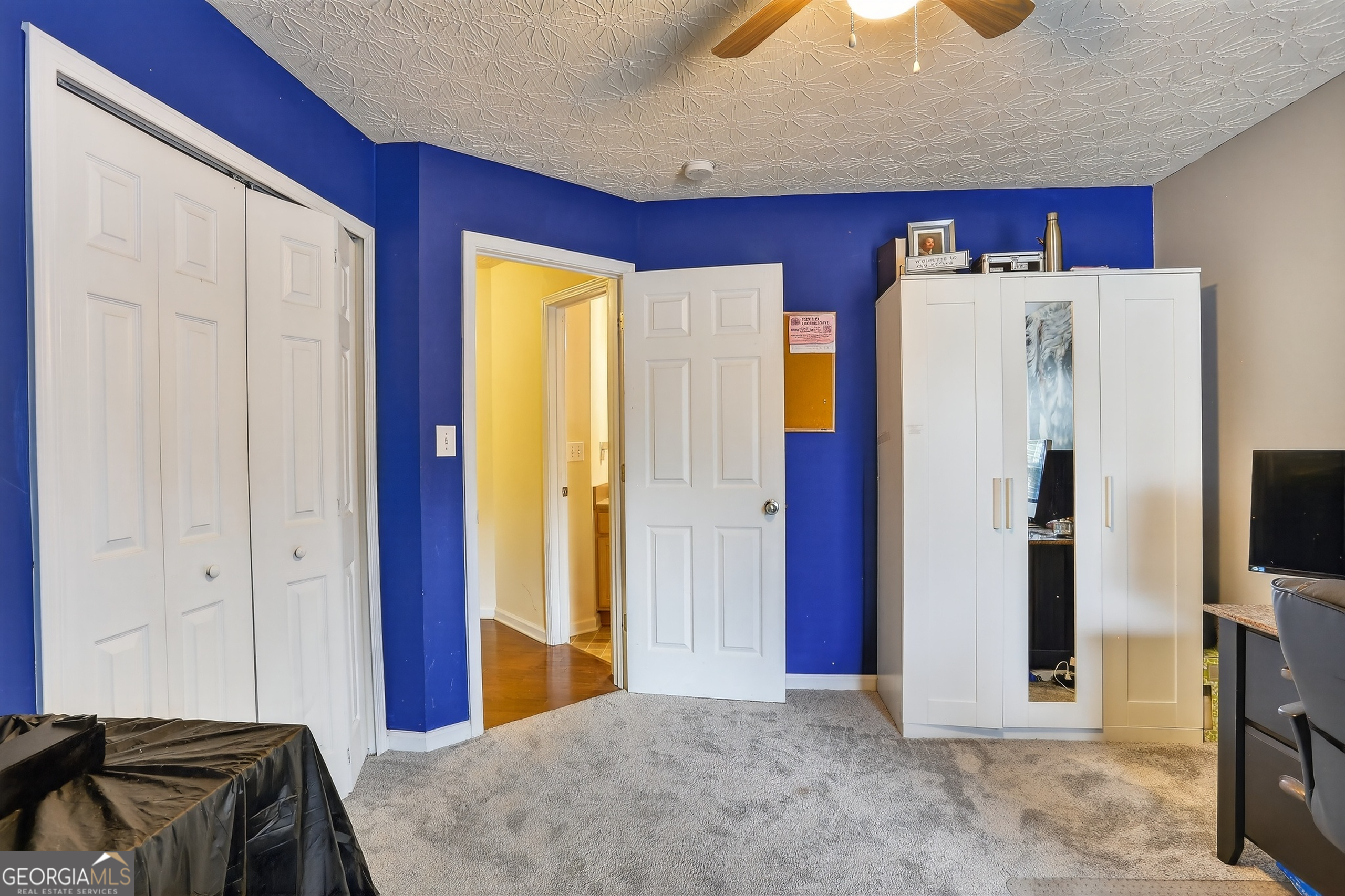 5556 Cascade Run South Fulton, GA 30336 - Photo 30 of 35 a bedroom with a bed and a chandelier