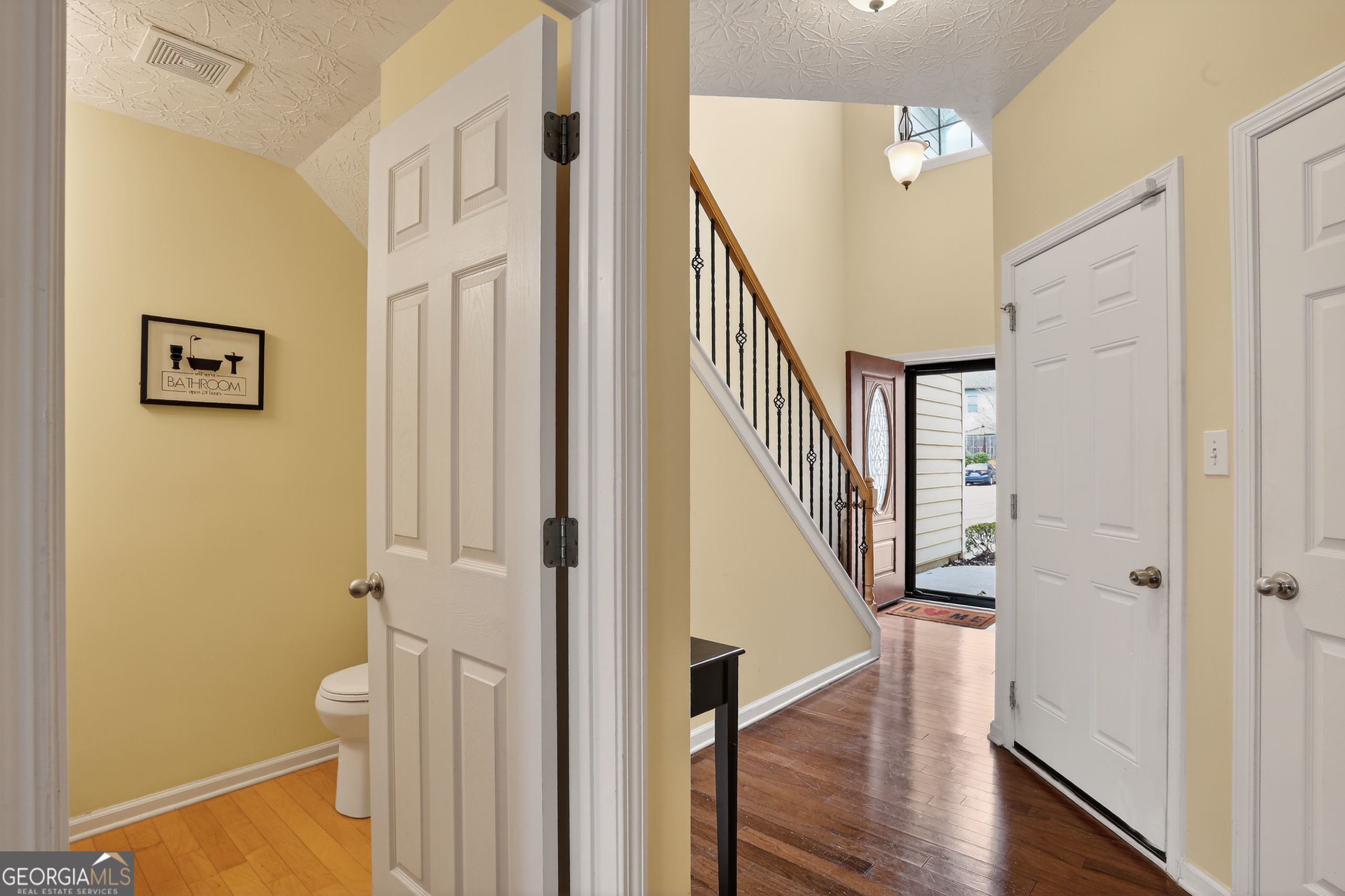 5556 Cascade Run South Fulton, GA 30336 - Photo 4 of 35 a view of a hallway with wooden floor and staircase