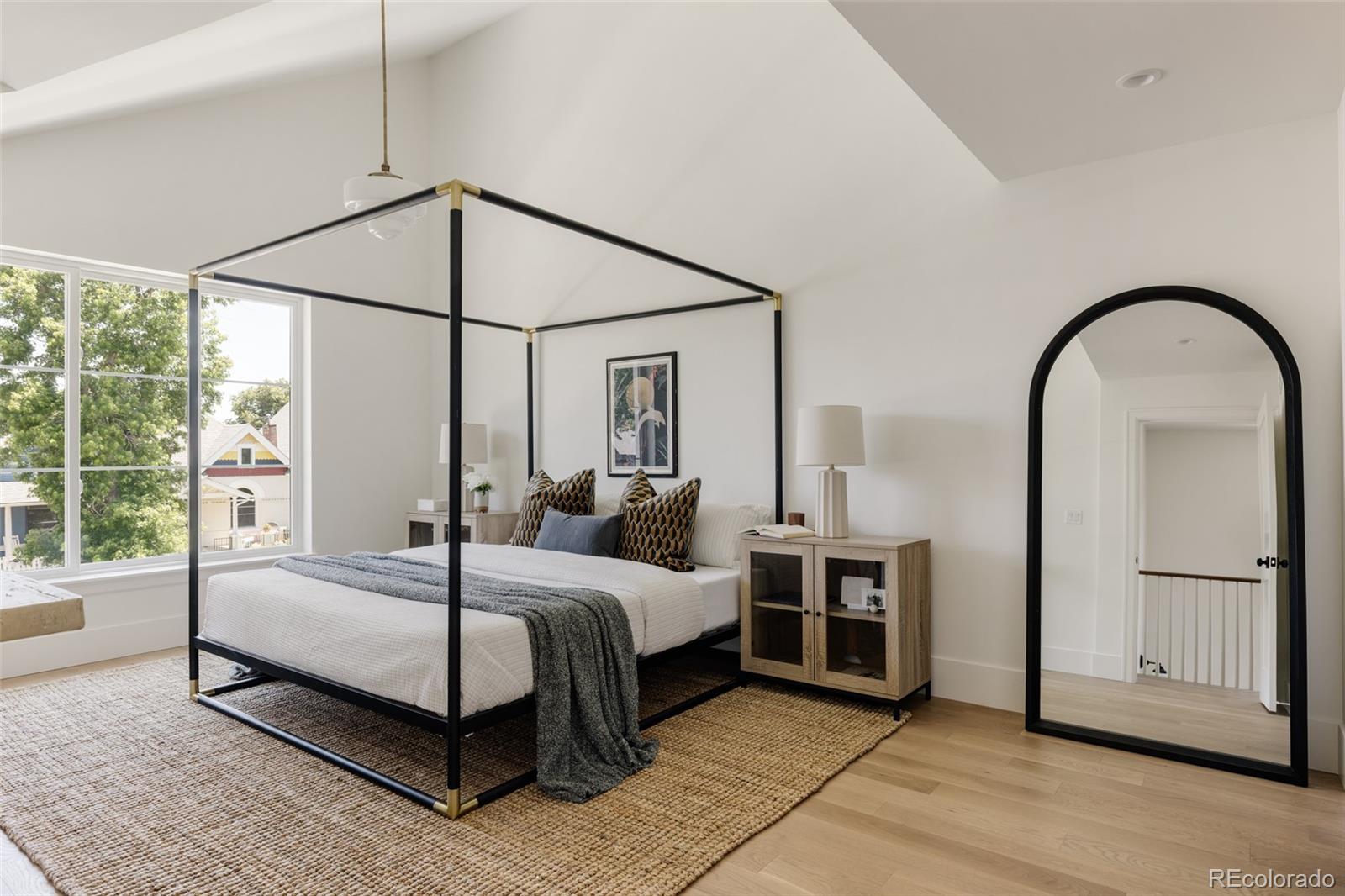4131 Quivas Street Denver, CO 80211 - Photo 20 of 44 a bedroom with a bed a table and large window
