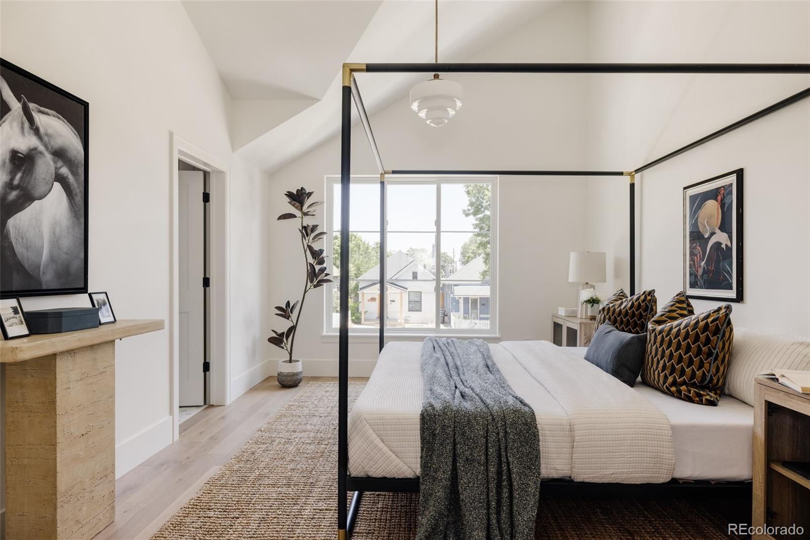 4131 Quivas Street Denver, CO 80211 - Photo 21 of 44 a bedroom with a bed and a flat screen tv