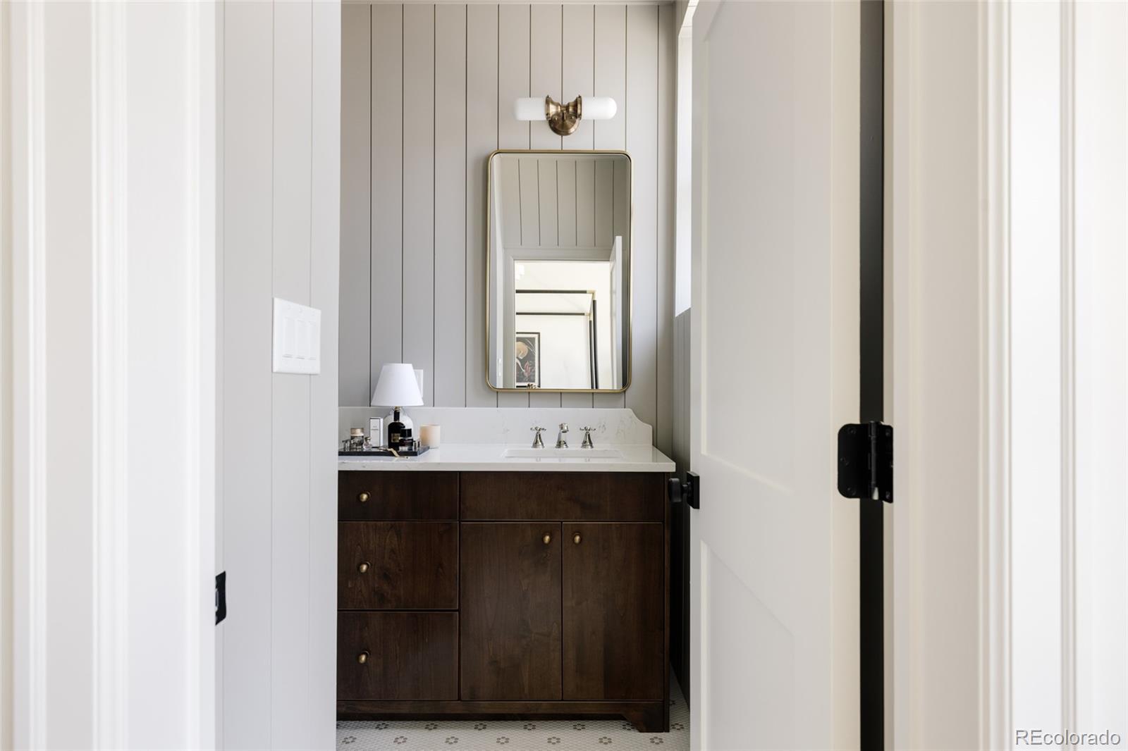 4131 Quivas Street Denver, CO 80211 - Photo 22 of 44 a bathroom with a sink and a mirror