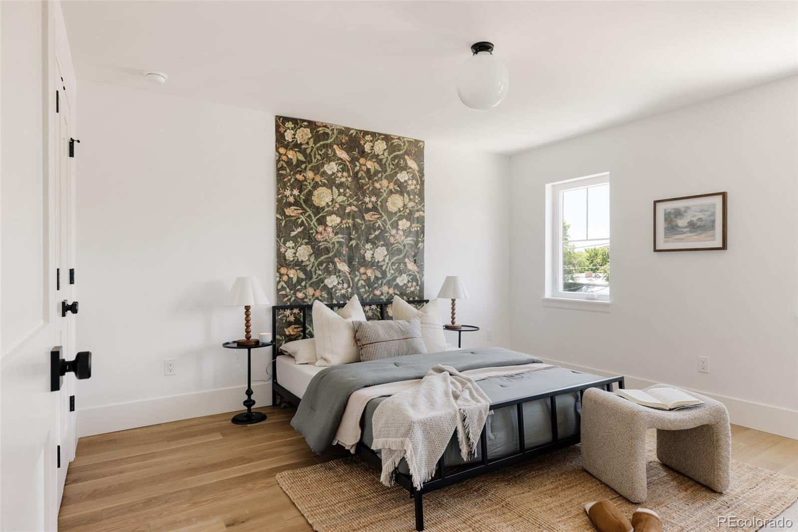 4131 Quivas Street Denver, CO 80211 - Photo 25 of 44 a spacious bedroom with a bed and a window