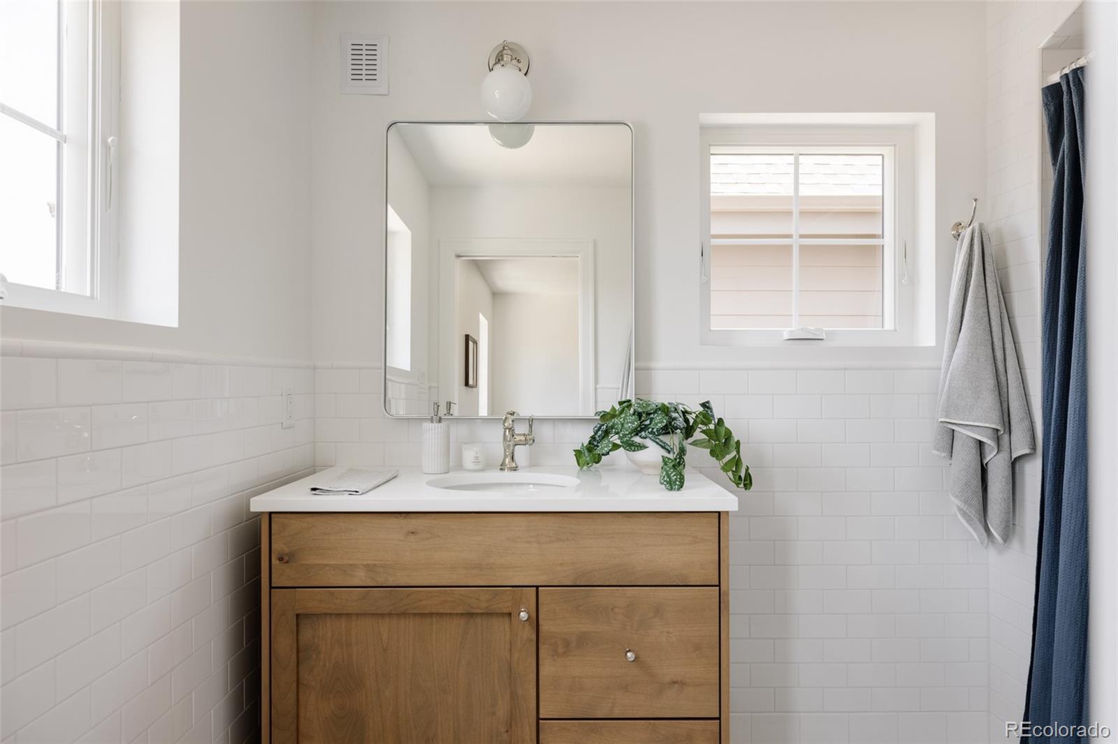 4131 Quivas Street Denver, CO 80211 - Photo 27 of 44 a bathroom with a sink and a mirror