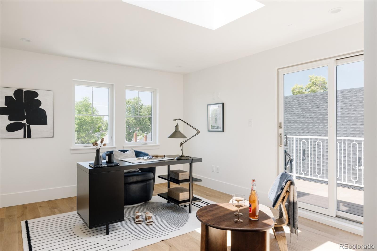 4131 Quivas Street Denver, CO 80211 - Photo 32 of 44 a view of a workspace with wooden floor and a window