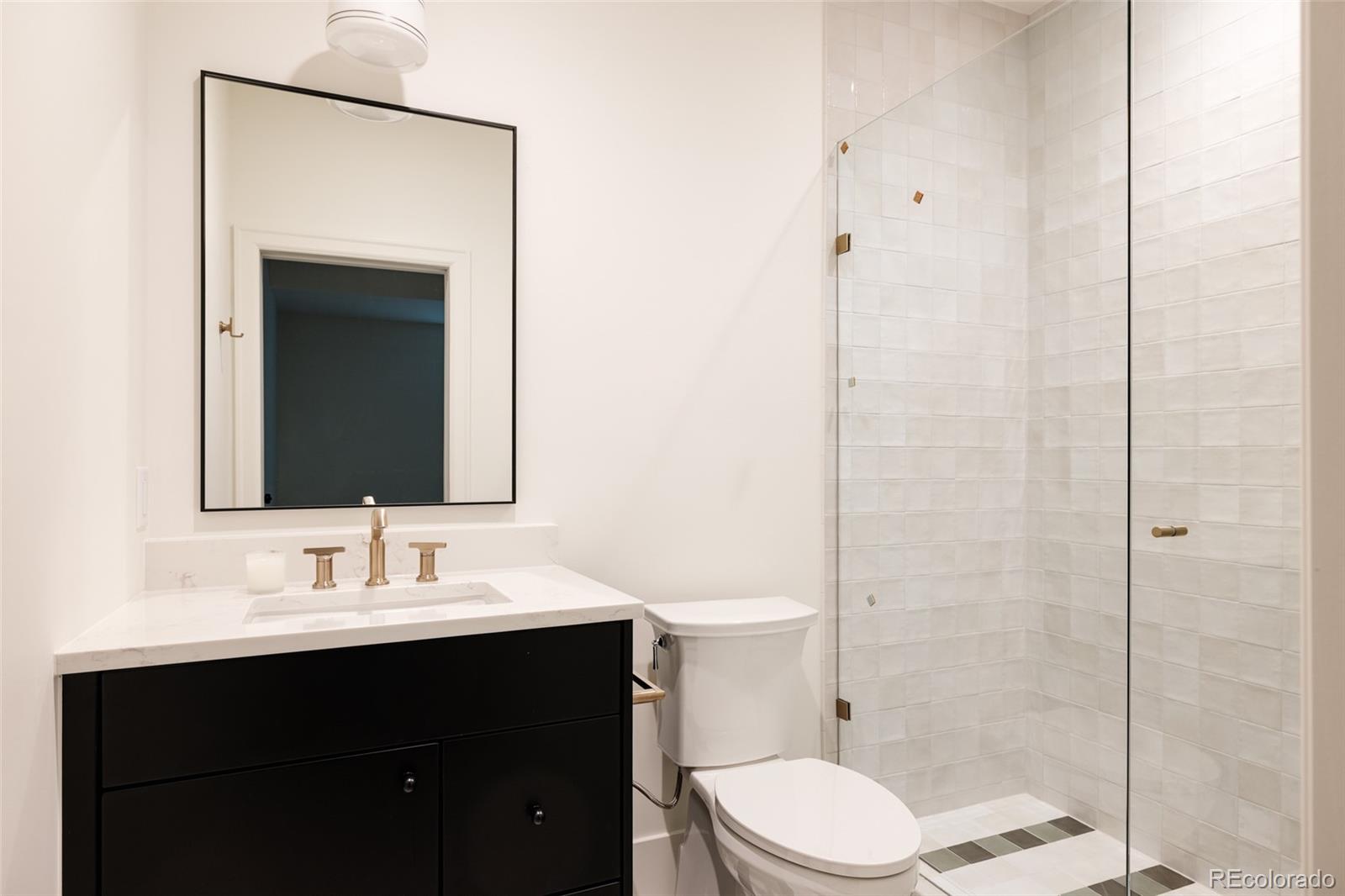 4131 Quivas Street Denver, CO 80211 - Photo 39 of 44 a bathroom with a sink a toilet and shower