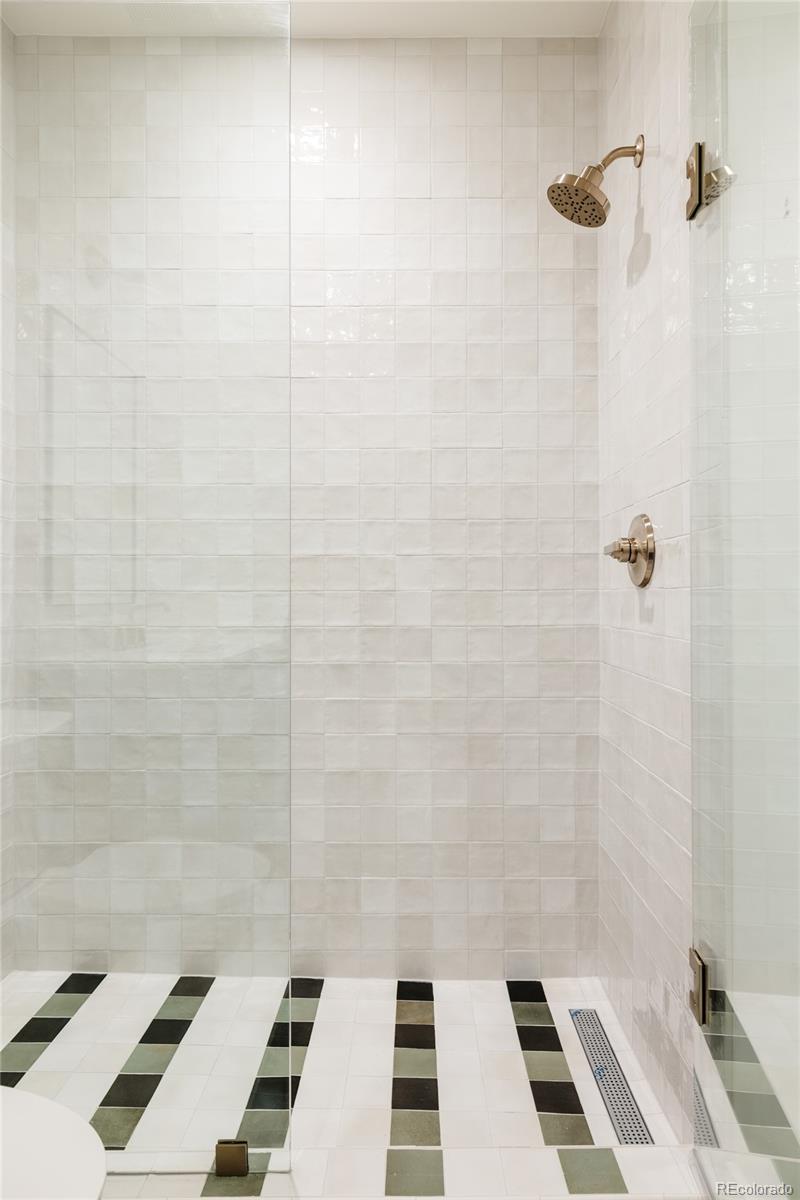4131 Quivas Street Denver, CO 80211 - Photo 40 of 44 a bathroom with a sink a toilet and a shower
