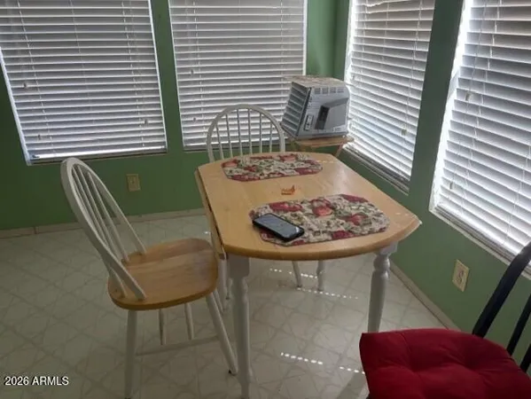 a view of a room that has a couch and a potted plant