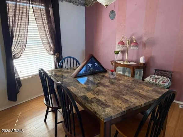 a view of a dining table and chairs in a patio