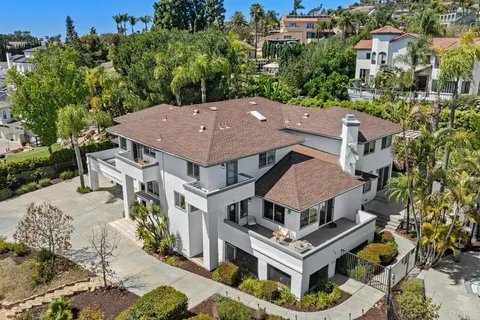an aerial view of a house with a swimming pool and a yard