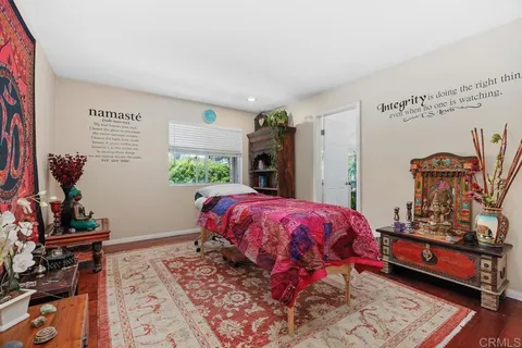 a bed sitting in a bedroom next to a window
