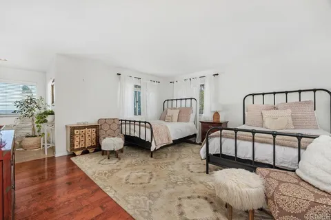 a bedroom with furniture and a window