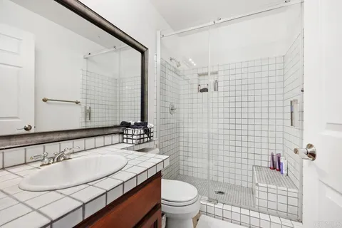 a bathroom with a sink toilet and shower