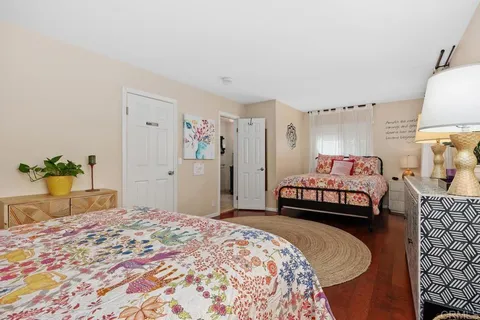 a bedroom with a bed and a chair