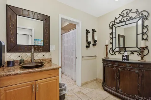 a bathroom with double vanity sinks and a mirror
