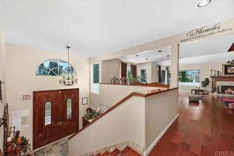 a view of living room kitchen with furniture and wooden floor