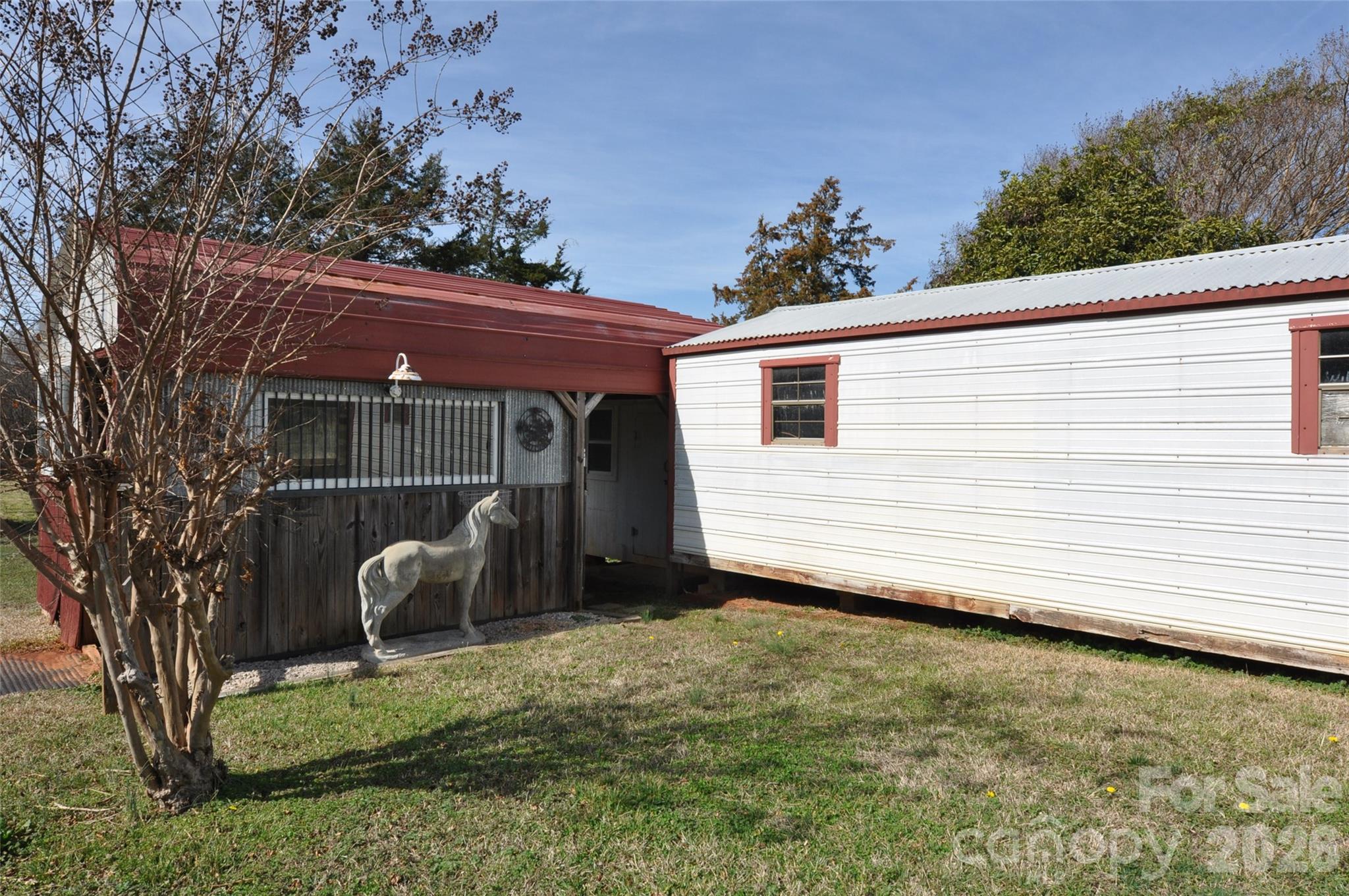 1316 Cornwell Road Blackstock, SC 29014 - Photo 28 of 48 a view of a backyard with a small cabin and a chair