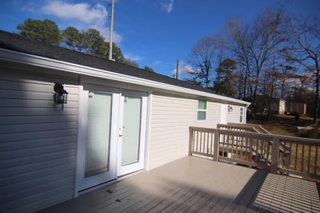 a view of a house with a wooden deck