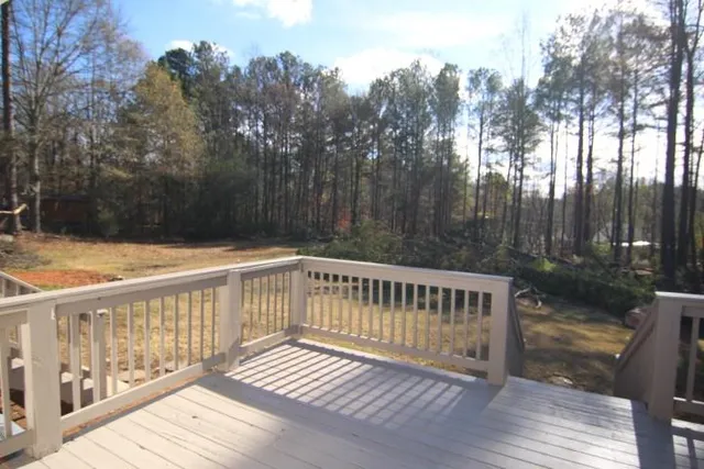 a view of wooden deck and a yard