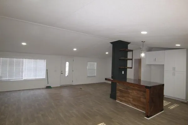 an empty room with windows and pillars in it